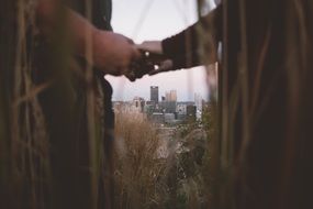 hands of lovers on the background of the cityscape in the distance