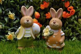 figures of easter hares on green grass