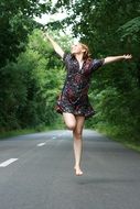 Girl on the road near the forest