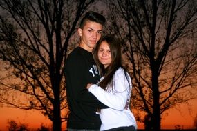 young Couple in Love posing at dusk