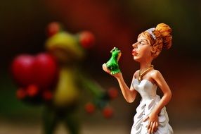 bride with a green frog in her hands close-up