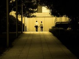 couple in love at the end of a park alley