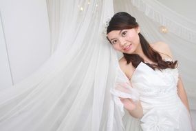 asian bride in white dress in photo studio