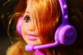 beautiful doll with purple headphones close-up