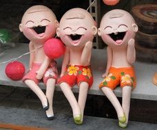 Figures of laughing boys
