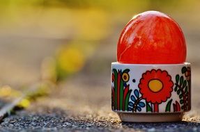 red Easter egg in a beautiful stand