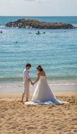 young asian couple in Wedding clothing on beach at sea, Hawaii