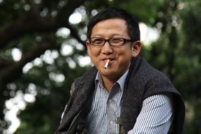 middle-aged man smokes a cigarette