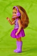 little doll in a bright purple dress