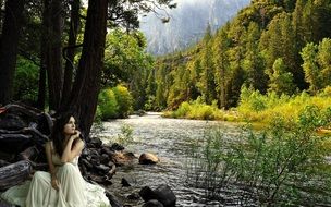 sad beautiful woman by the river