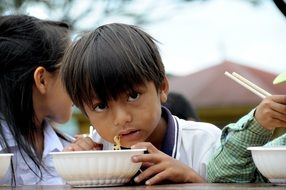Child eating Noodle breakfast vietnam