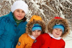 Twins, Brother and Sister, posing with elder brother at snowy winter