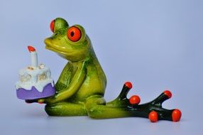 figure of the green frog with birthday cake