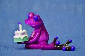 purple ceramic frog with birthday cake