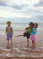 two child boys and girl on Beach at Sea