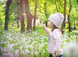 happy child on a meadow with dandelions