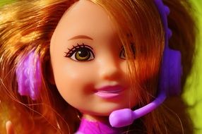 bright red doll in headphones with a microphone