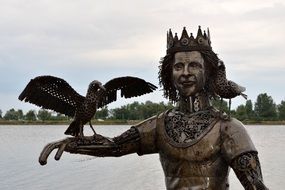 fantasy king with bird on hand, metal sculpture at Sea