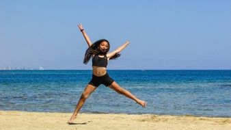 happy girl dancing on the beach