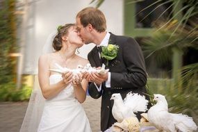 Wedding, Kissing couple with white doves