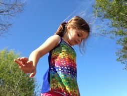 little girl in a bright dress on a sunny day