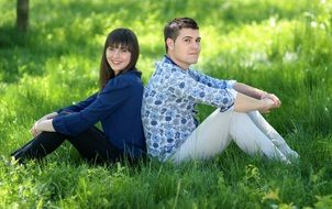 romantic couple sitting on the green grass