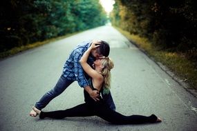 young Couple hugging on Road through Forest