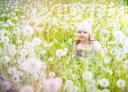 cute girl on the dandelion meadow