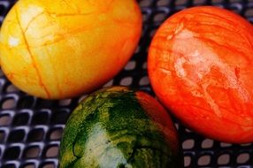 three colorful easter eggs