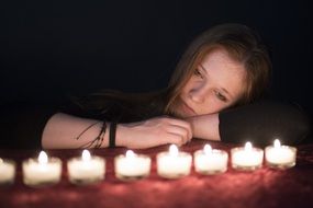 Woman in the meditation with candles