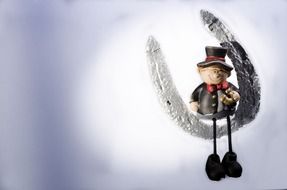figure man sitting on a horseshoe greeting card happy new year