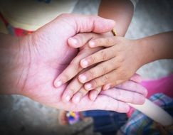 child hands in hands of grandmother