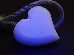 purple heart-shaped pendant on a dark background