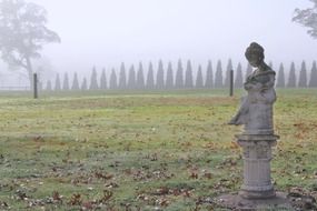 stone statue in autumn park