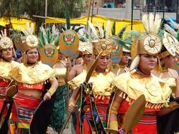 girls in golden carnival costumes