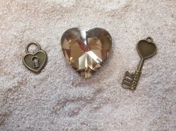 key and lock near a glass heart