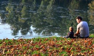 Father and child near the water