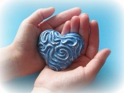 blue heart in hands
