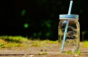 glass jar with a straw for a summer drink