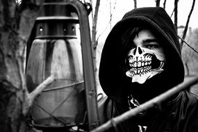 black and white photo of a man in a skeleton mask