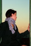 girl looks out of the window