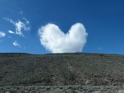 cloud like a heart over a mountain