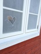 image of heart on frozen windows