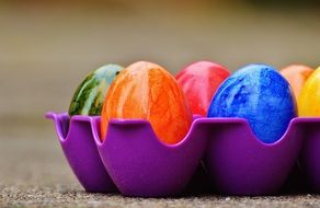 colored easter eggs in a purple tray