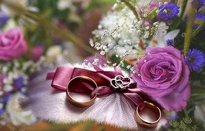 summer related wedding rings on a floral background