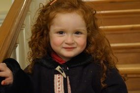 girl with curls on the stairs