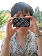 Chineese woman with Short Hair looking at cell phone