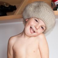 little baby in a knitted beige hat