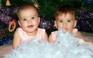 photo of little sisters under the christmas tree