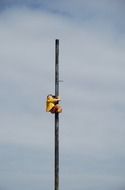 child girl on pole at sky